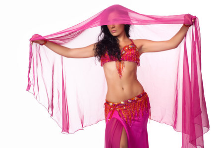 Exotic belly dancer wearing a hot pink costume and wrapped in a hot pink veil  Isolated on white  
