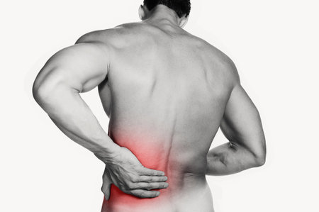 Black and white photo of a muscular man with a backache  Red selective color further illustrates...