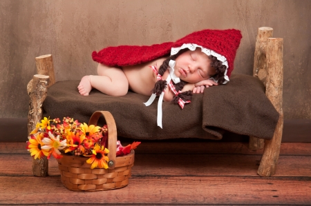 Newborn Baby Girl Wearing a Little Red Riding Hood Costumeの写真素材