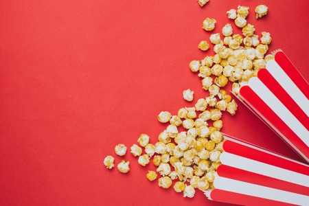 Popcorn on a red background top view in cineemaの写真素材