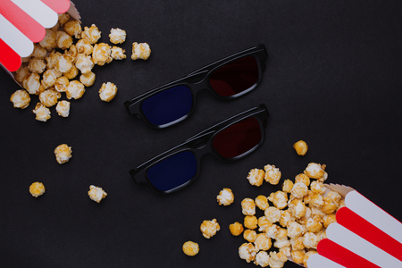 3D Glasses and popcorn with keyboard on a black background top viewの写真素材
