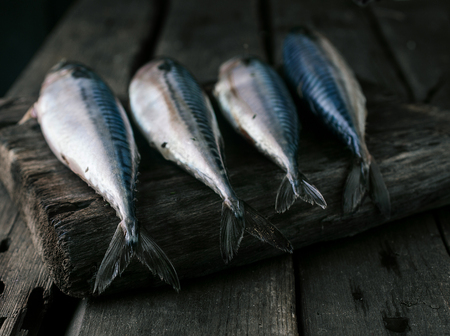 Fresh sea fish on wooden table top viewの写真素材