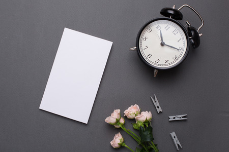Empty white notepad with coffee and alarm clock on grey background in vintage styleの写真素材