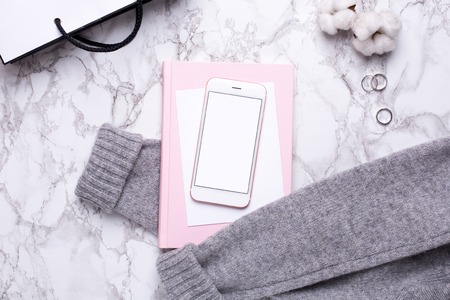 Women business day with mobile phone and pink notebook on marble table top viewの写真素材