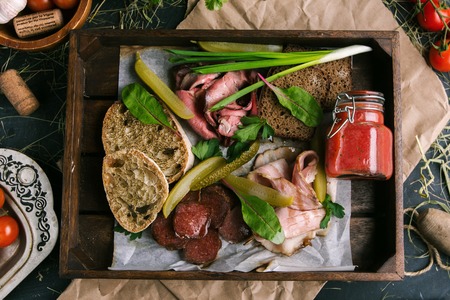 Meat snacks with toast and vegetables in a restaurantの写真素材