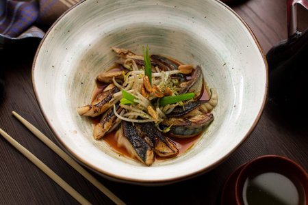 Asian food: fish with sprouts and peanuts in a restaurant side viewの写真素材
