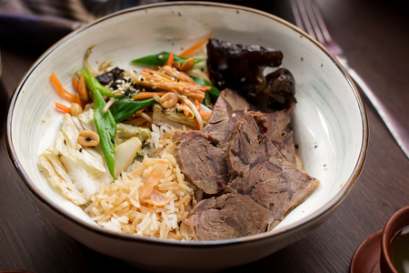 Asian food: beef with rice and greens side viewの写真素材