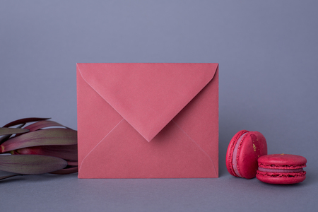Envelopes burgundy color and flower on gray background side viewの写真素材