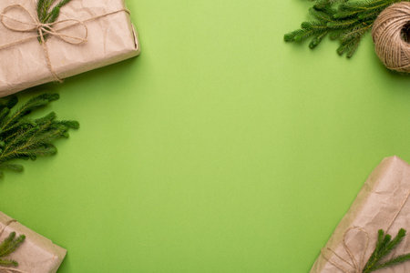 Green background with eco gifts with green plants in craft paper top vieew