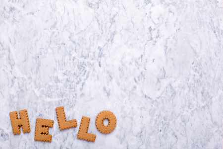 Letters cookies Hello on marble background top viewの写真素材