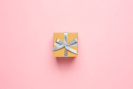 Gift or present box on pink table with space for text. Composition for birthday, mother day or...