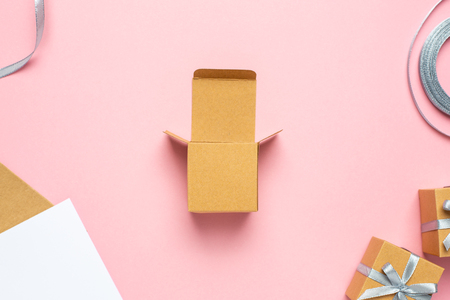 Open empty gift box on pink table. Colorful Gift box with ribbon bow present on holidayの写真素材