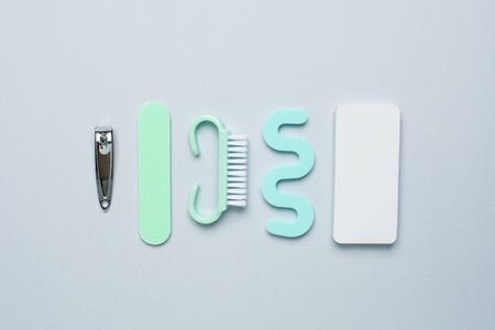 Pedicure manicure tools , nail file, pedicure scissors and separator for the fingers on blue background top viewの写真素材