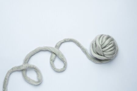 Thick grey yarn on blue background minimal style top viewの写真素材