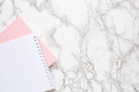 Marble background with white and pink notebook top view. Women business dayの写真素材