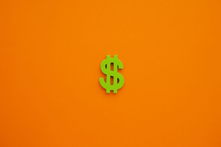 American dollar symbol on orange background. Green money top view