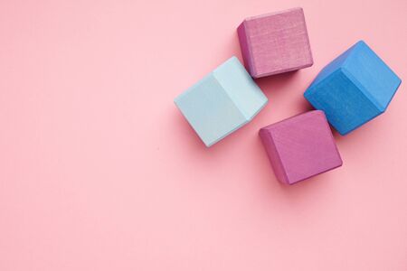 Colorful wooden cubes on pink background top view.Creativity toys. Children's building blocks.の写真素材