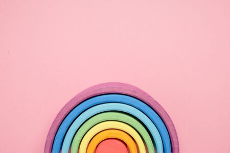 Colorful Waldorf wooden rainbow in a montessori teaching pedagogy on pink background top viewの写真素材