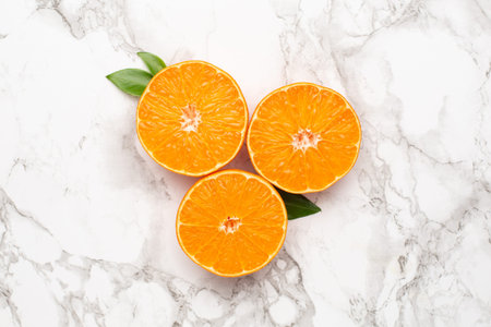 Fresh orange mangerine on marble background, fruit flatlay, summer minimal and kinfolk compositon top viewの写真素材