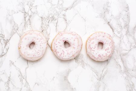 Sweet strawberry donuts on pink background isolated flat lay top view , minimalism, foodの写真素材