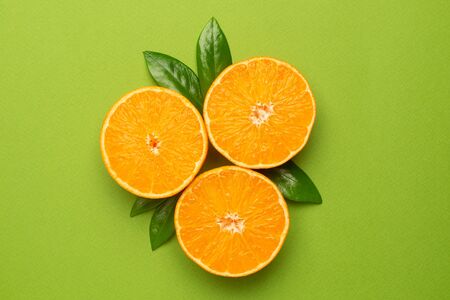 Tangerine on an green background, fruit flatlay, summer minimal compositon top voewの写真素材