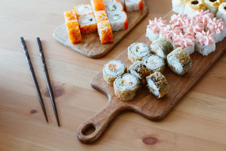 Japanese kitchen rolls on a wooden background, home delivery side viewの写真素材