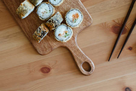 Japanese kitchen rolls on a wooden background, home delivery side viewの写真素材