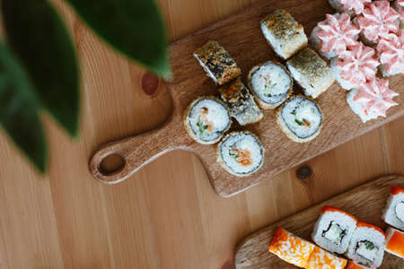 Japanese kitchen rolls on a wooden background, home delivery top viewの写真素材