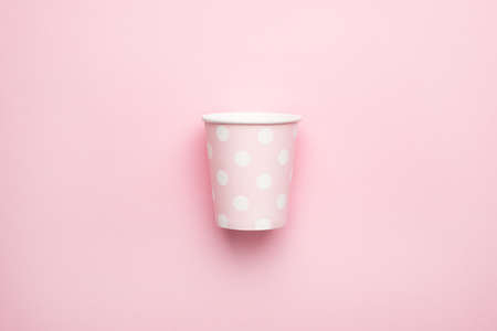 Pink in polka dot cardboard cups, eco dishes and conscious consumption top viewの写真素材