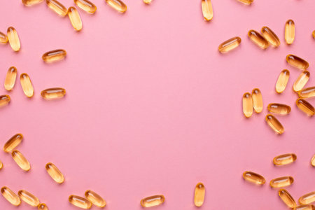Vitamins Omega 3 6 9 fish oil , vitamin D on a pink background for health lifestyle with copyspace...