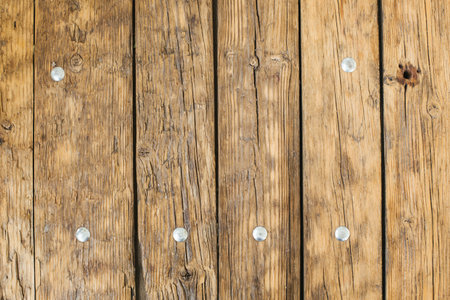 Old natural light wooden table with iron nails texture background top viewの写真素材