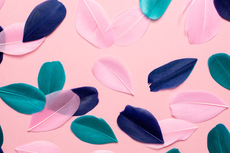 Beautiful abstract pink green and blue feathers on pastel background and soft white pink feather texture on colorful pattern, colorful background, colorful feather top viewの写真素材