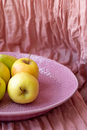 Pear and apple on a pink fabric background.Fresh fruits in minimal trend conceptの写真素材