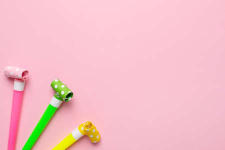 Bright festive background of pink color for a birthday or other holiday, with pipes pink, yellow and green colour top viewの写真素材