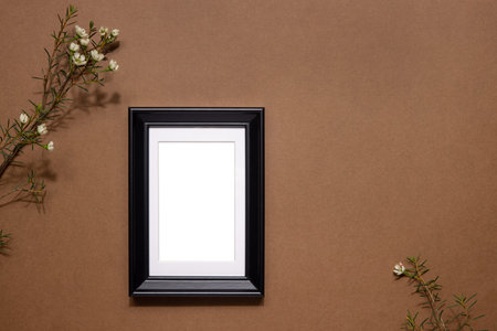 Autumn composition. Photo frame, dried white flowers on brown neutral background. Autumn, fall concept. Flat lay, copy spaceの写真素材