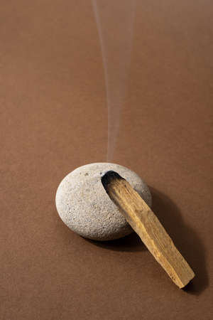 Clearing negative energy and restoring tranquility and calm emotions with Palo Santo.Wood stick on stone vertical shotの写真素材