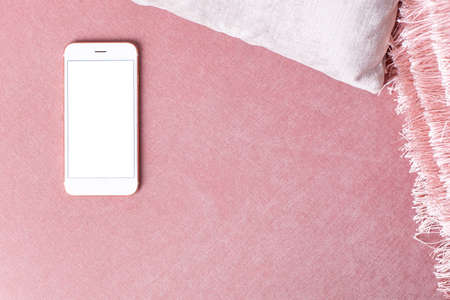 Mobile phone mock up with white screen on pink chair in modern interiorの写真素材