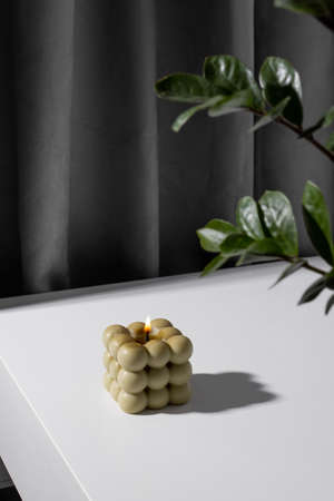Aromatic scented soy candle with smoke on beige brown textile background , modern bubble candle still lifeの写真素材