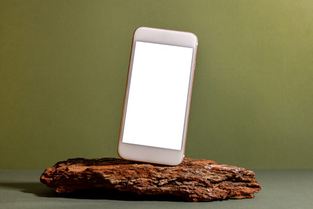 Mobile phone mock up on green Background , Rustic Style , technology and tree bark