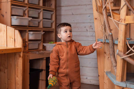 Boy toddler in kids room for decoration design. Modern wood Interior design. Light background. Montessori toysの写真素材