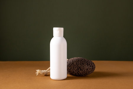 A set of empty white bottles with cosmetics and pumice on brown and green background . Eco-friendly cosmetics. The concept of cosmetic skin and body care, treatment, youth preservation.の写真素材