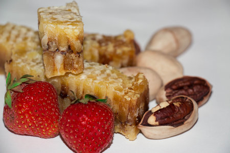 Still life with honeycombs strawberries, pecanの写真素材