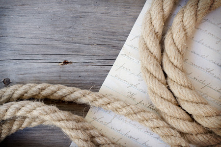 Rope and letter on dark woodの写真素材