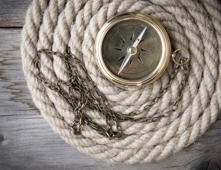 Antique compass and ropeの写真素材