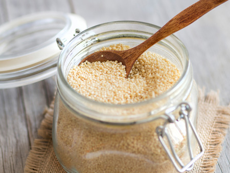 Millet in a glass jar with a spoonの写真素材