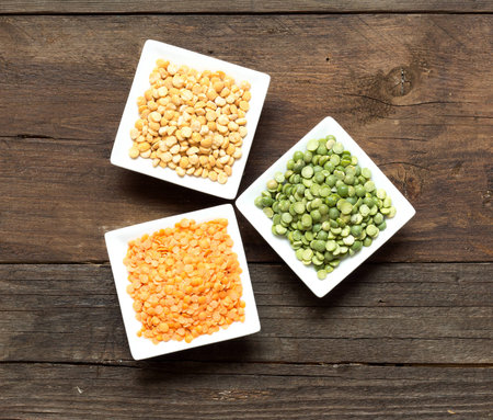 Legumes in bowls on a wooden table