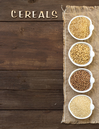 Cereals in bowls border with word Cereals on woodの写真素材
