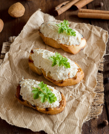 Toasted bread with a salted codfish mousse on a craft paperの写真素材