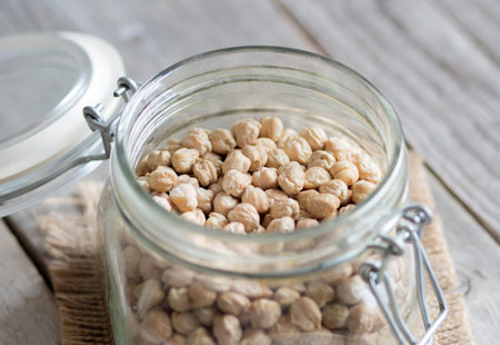 Chickpea in a glass jar on a wooden tableの写真素材