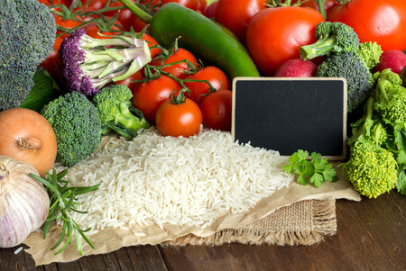 Basmati rice and vegatables on the old wooden tableの写真素材